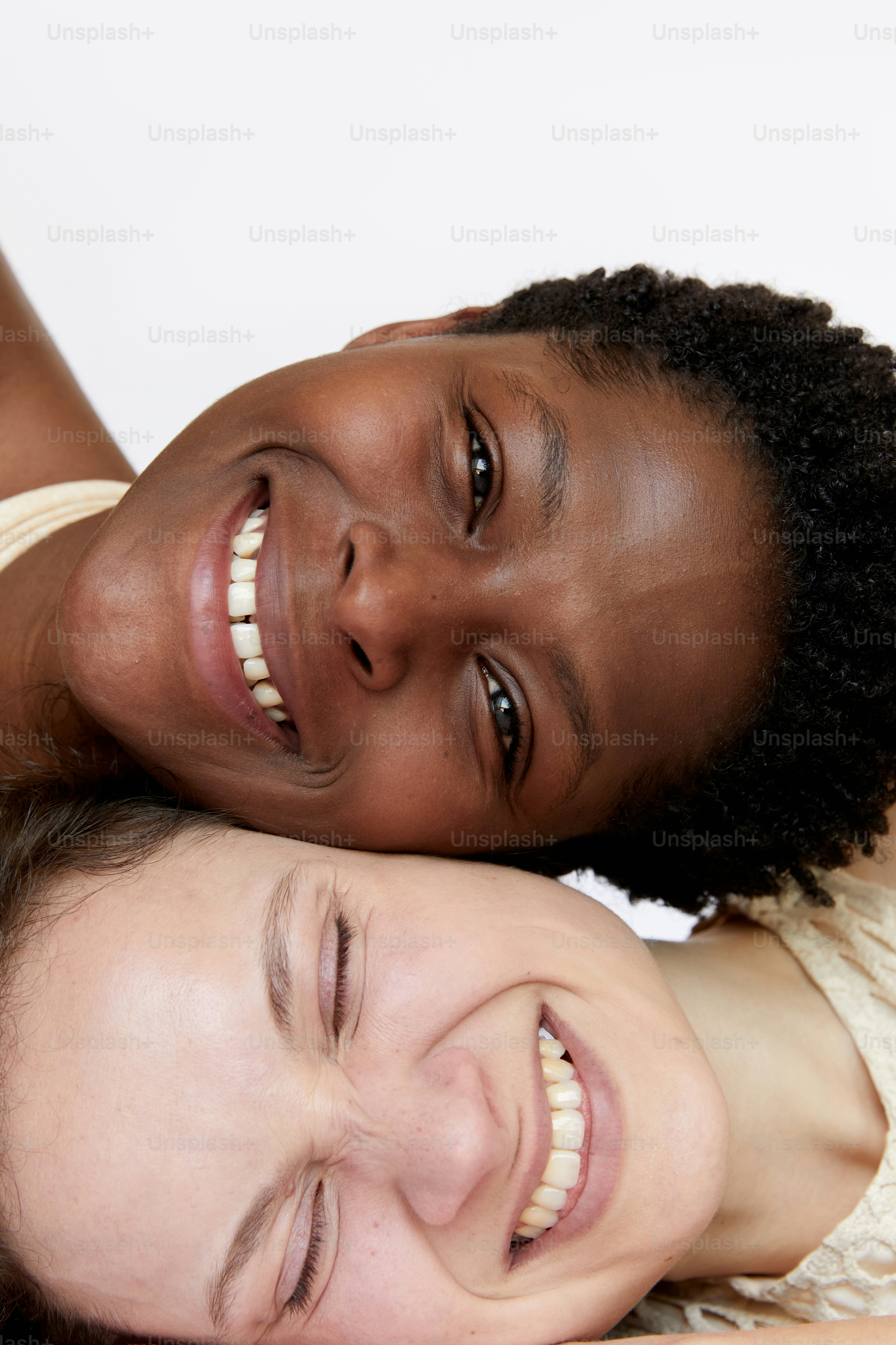 a couple of women laying next to each other