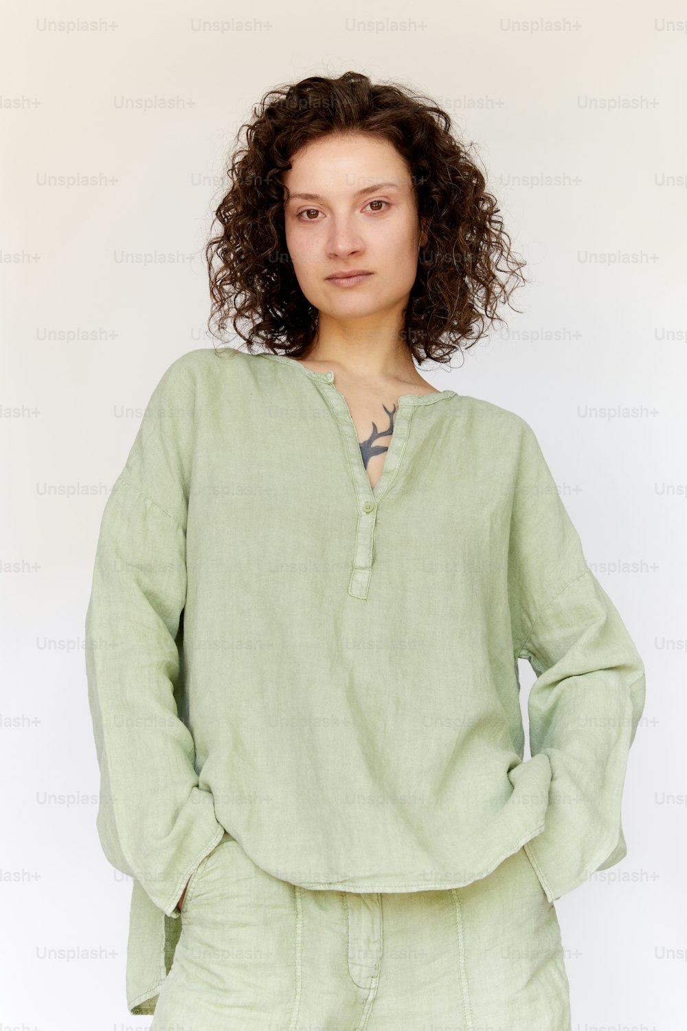 a woman with curly hair wearing a green shirt