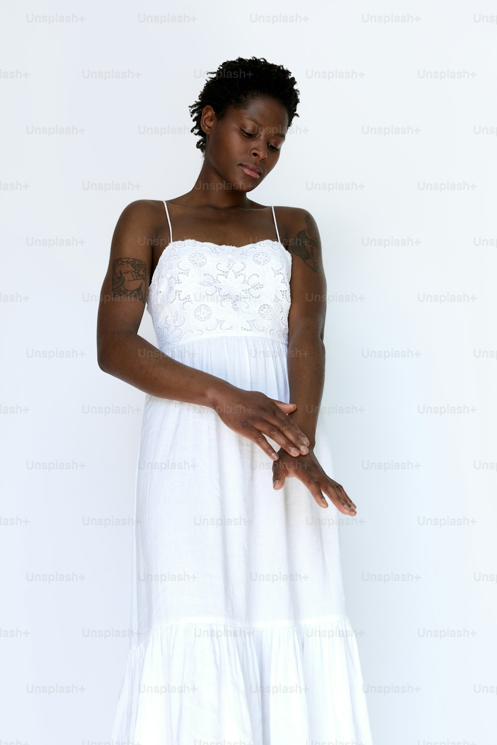 a woman in a white dress is posing for a picture