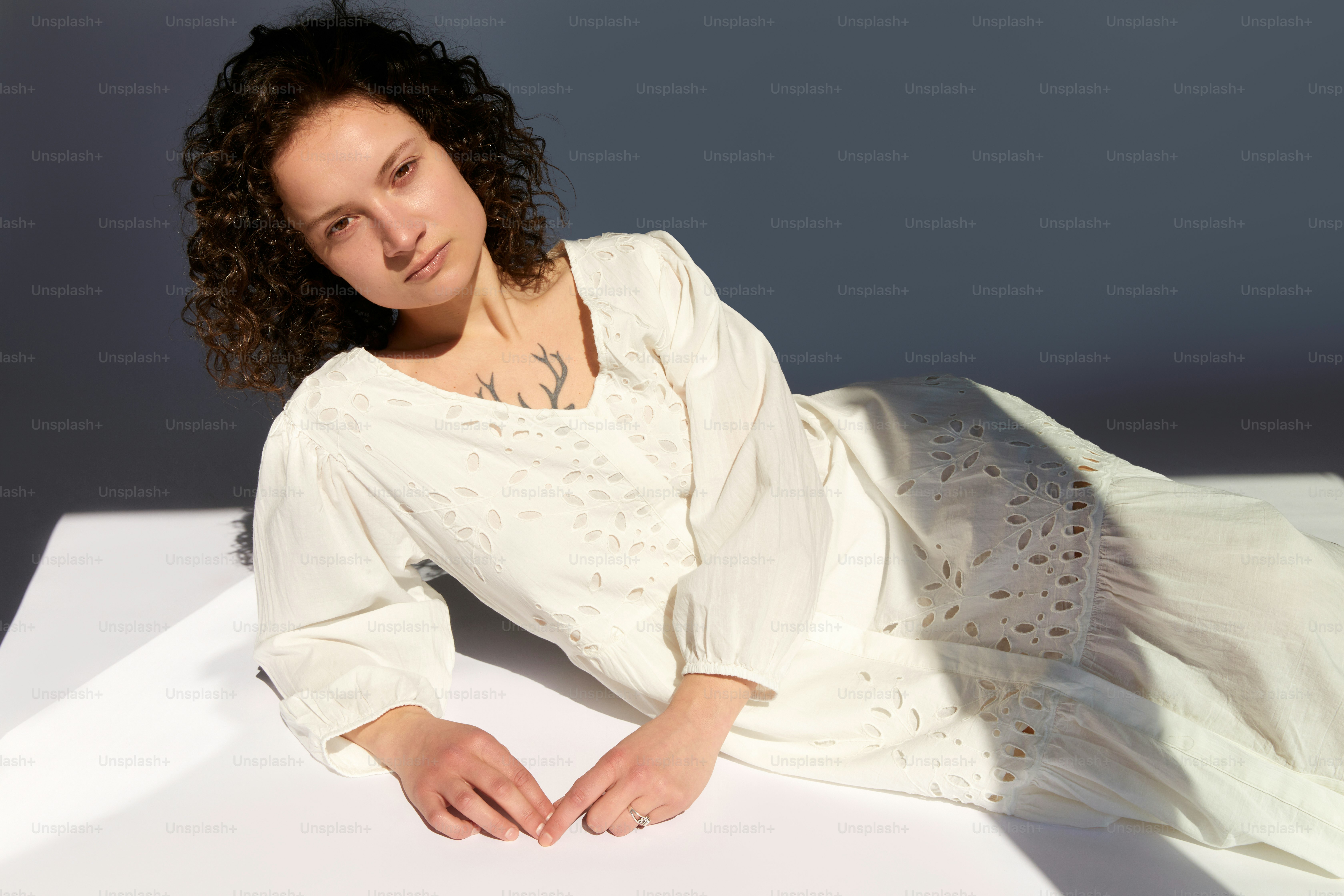 A woman in a white dress posing for a picture photo – Peaceful Image on ...