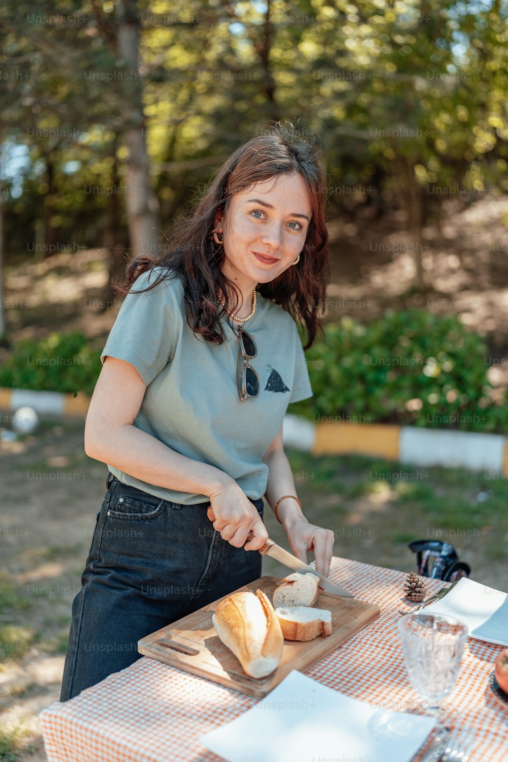 a woman cutting bread on a cutting board