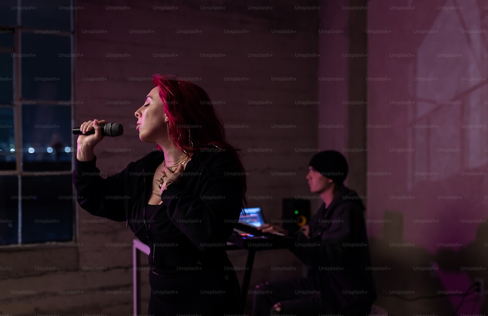 a woman with red hair singing into a microphone