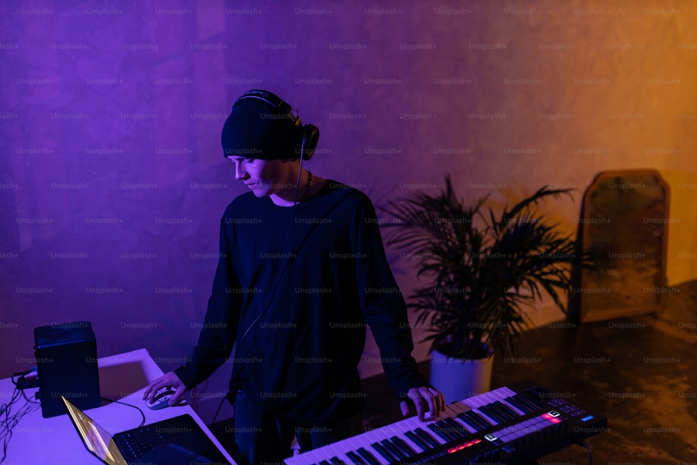 a man wearing headphones is playing a keyboard