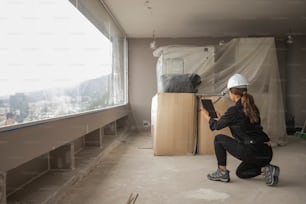 a woman in a white hard hat is working on a piece of wood