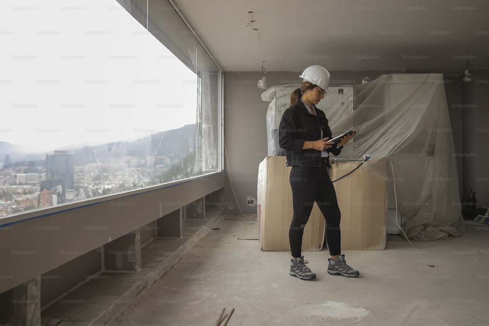 a woman standing in a room with a hose