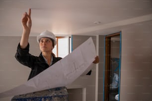 a woman in a hard hat holding a piece of paper