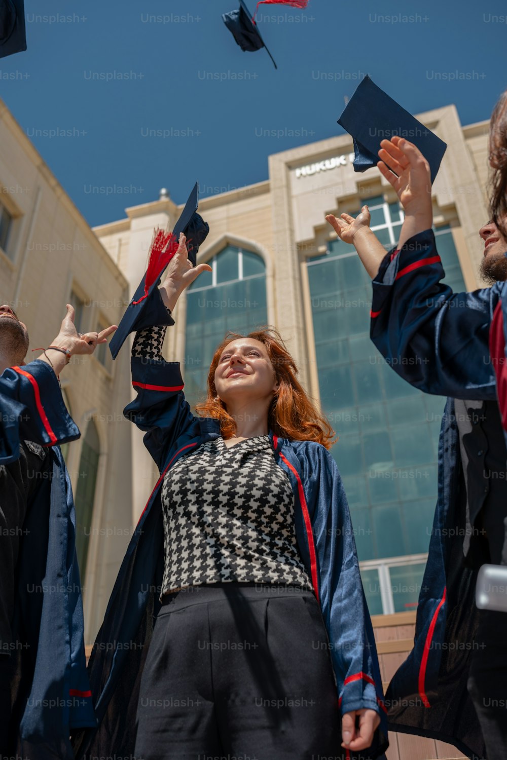 a group of graduates tossing their caps in the air