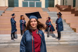 a woman in a graduation cap and gown