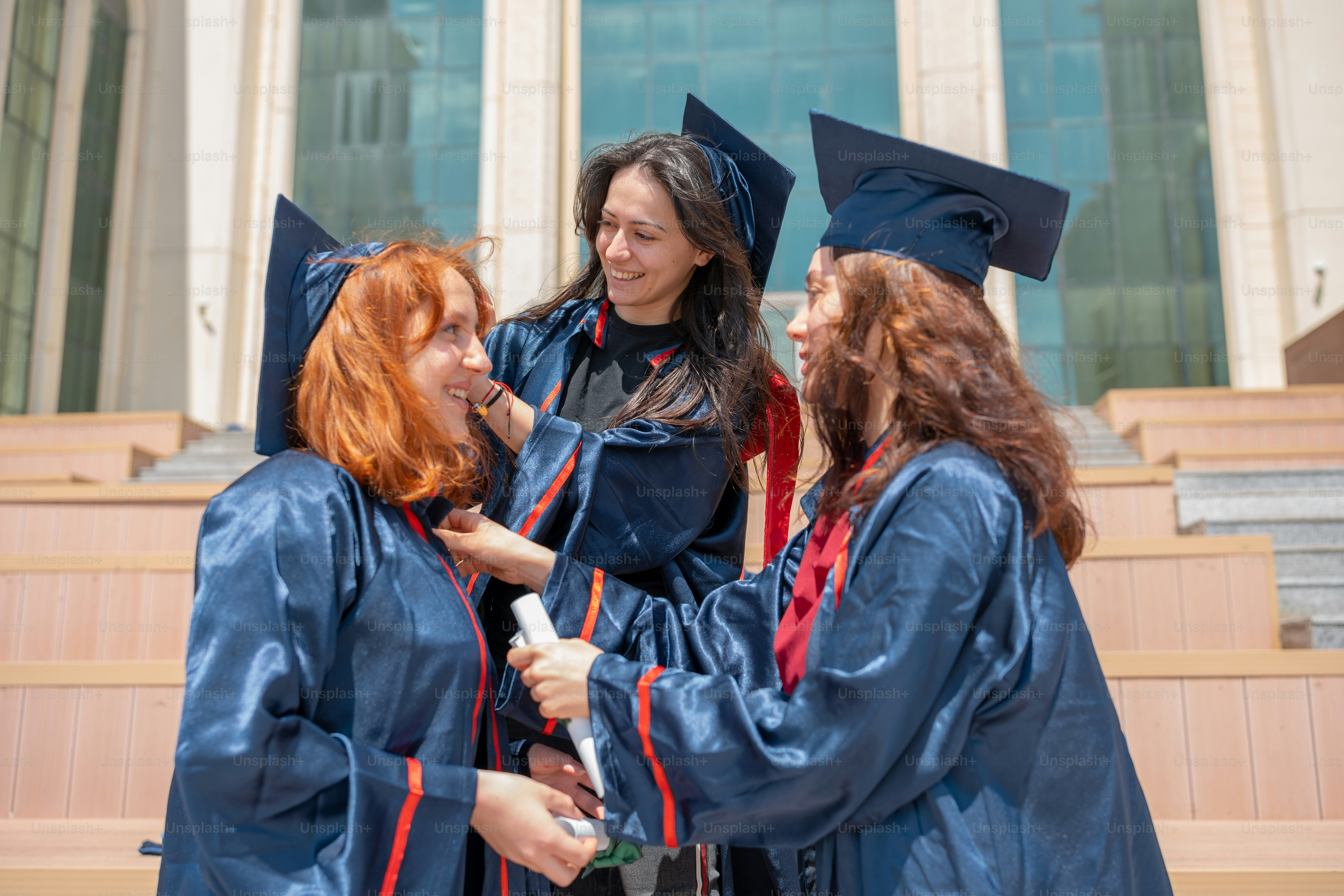 a group of women standing next to each other in graduation gowns
