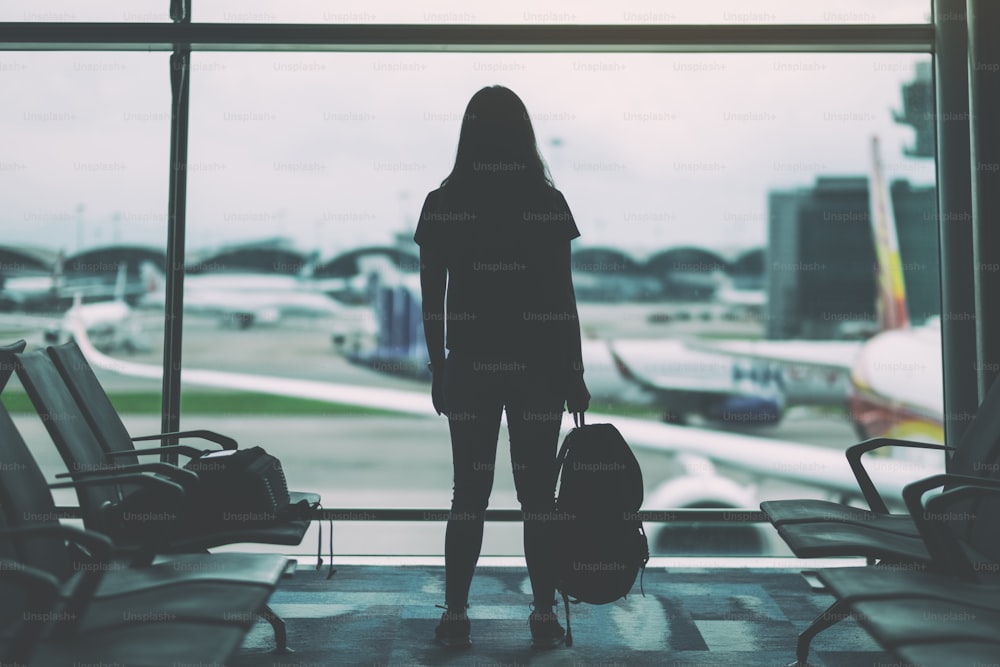 A woman traveler with backpack at the airport