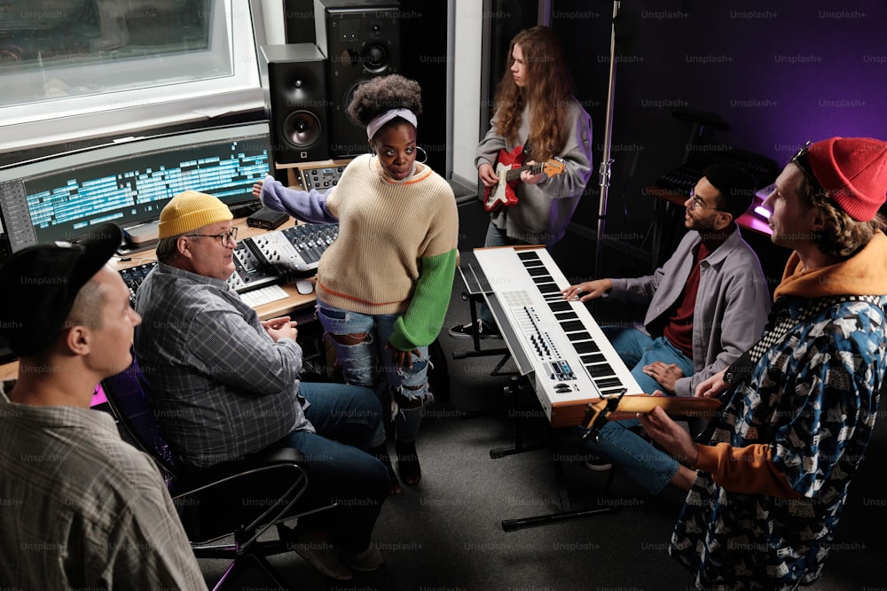 a group of people sitting around a keyboard