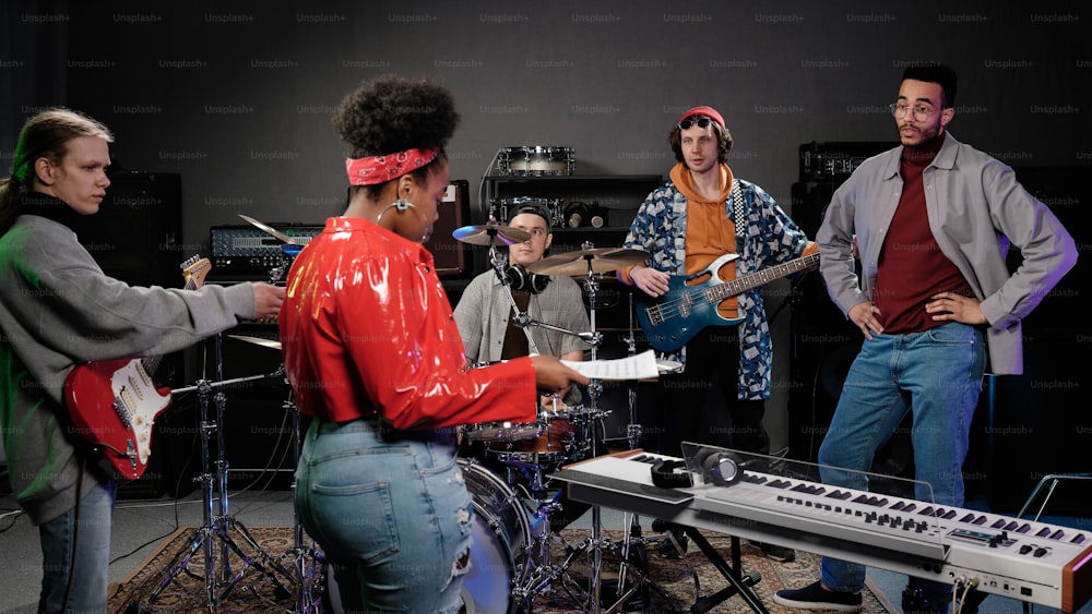 a group of people standing around a musical instrument