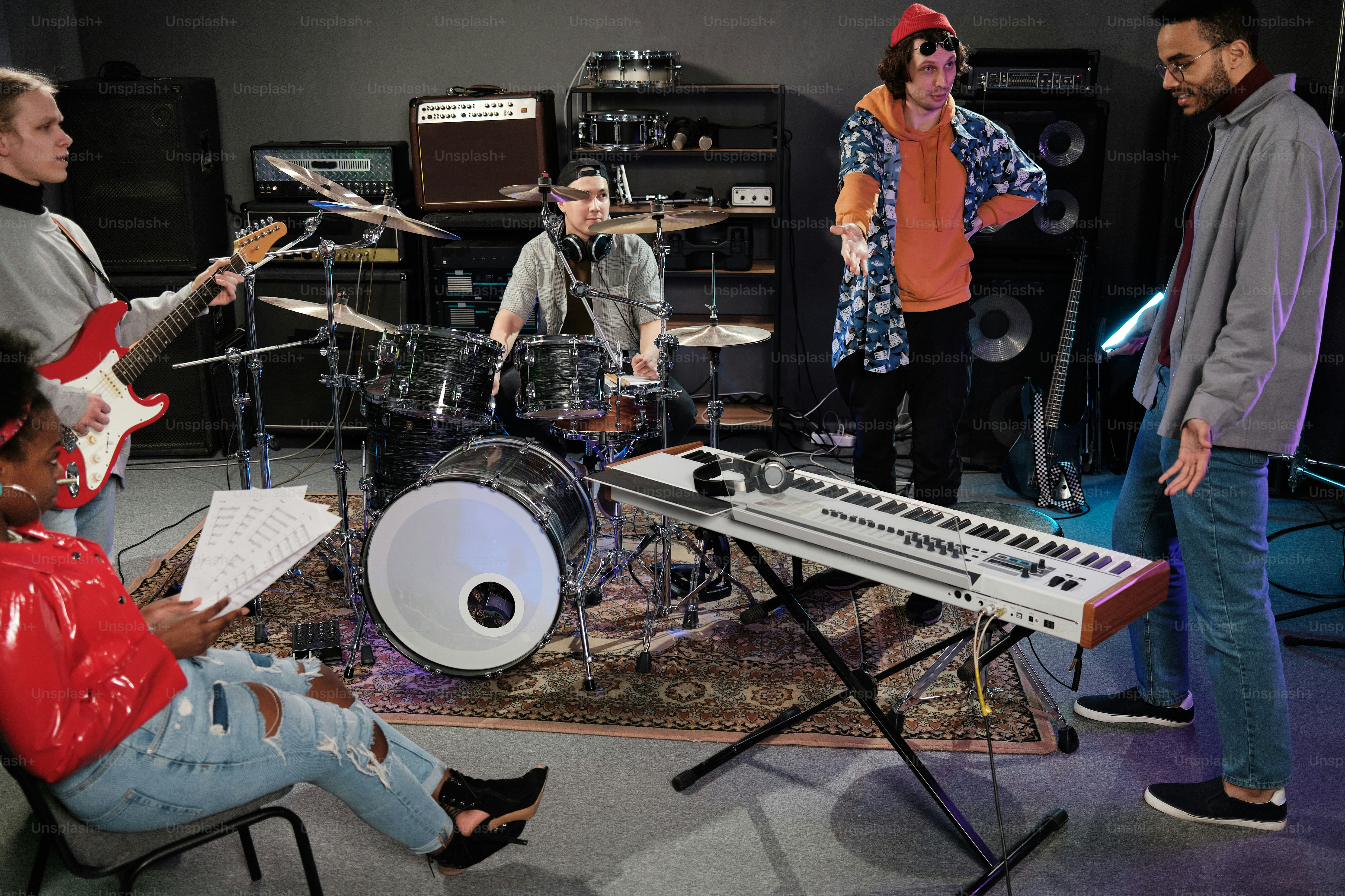 A group of people playing instruments in a room photo – Recording ...