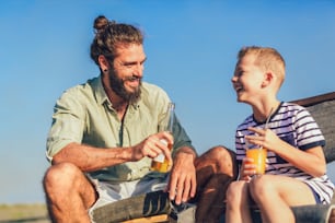 Father and son having fun at beach together portrait fun happy lifestyle