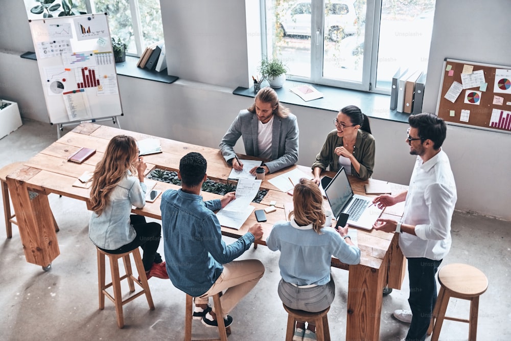 Top view of modern young people discussion business while working in the office