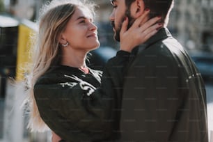 Happy together. Side view portrait of charming young woman looking at her boyfriend with love and smiling