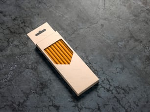 Pencils Set cardboard box Mockup on concrete floor, 3d rendering