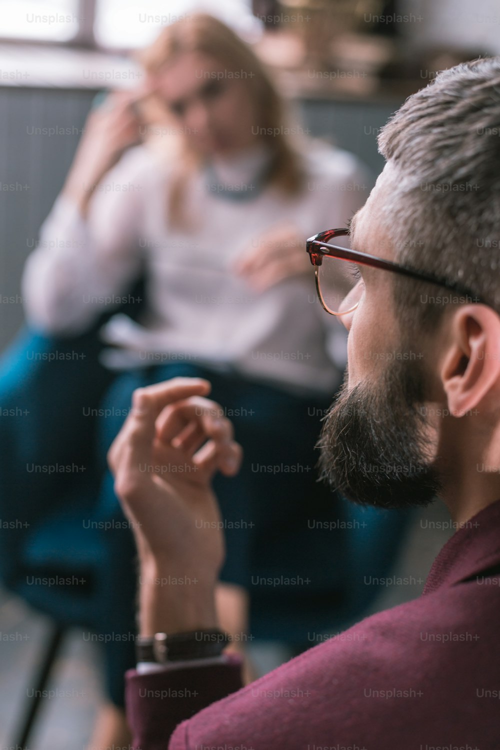 Businessman in glasses. Close up of bearded dark-haired businessman wearing glasses visiting psychologist
