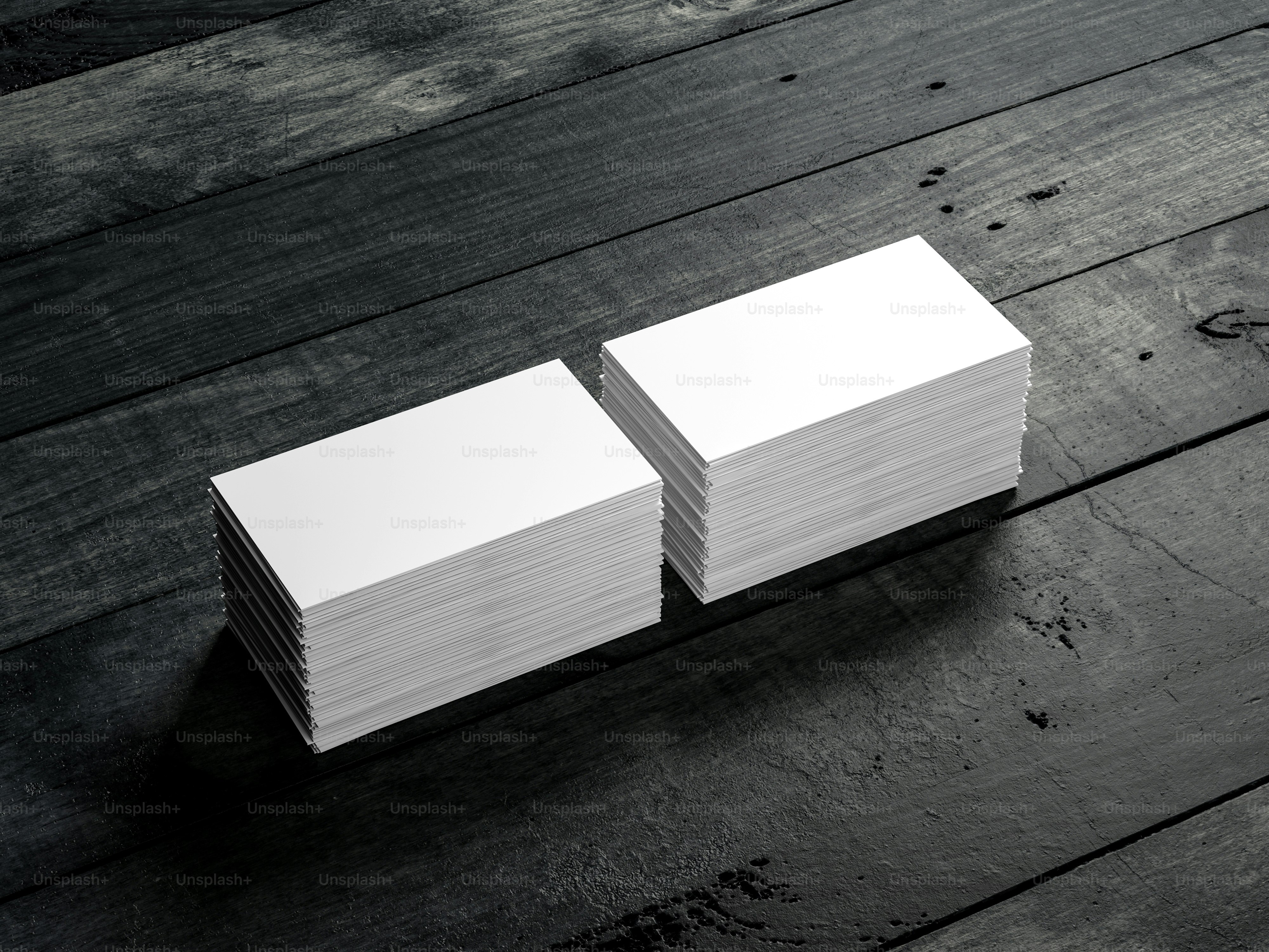 Two Stacks of white business cards mockup on black wooden table. 3d rendering