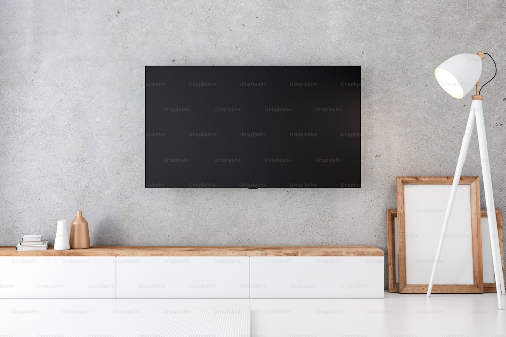 tv led con pantalla blanca en blanco, colgada en la pared de casa. maqueta  de televisión.