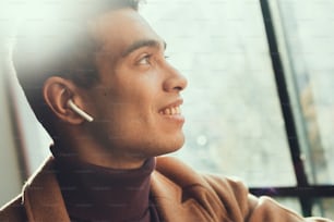 Enjoying the sunlight. Close up side view portrait of attractive gentleman looking away and smiling