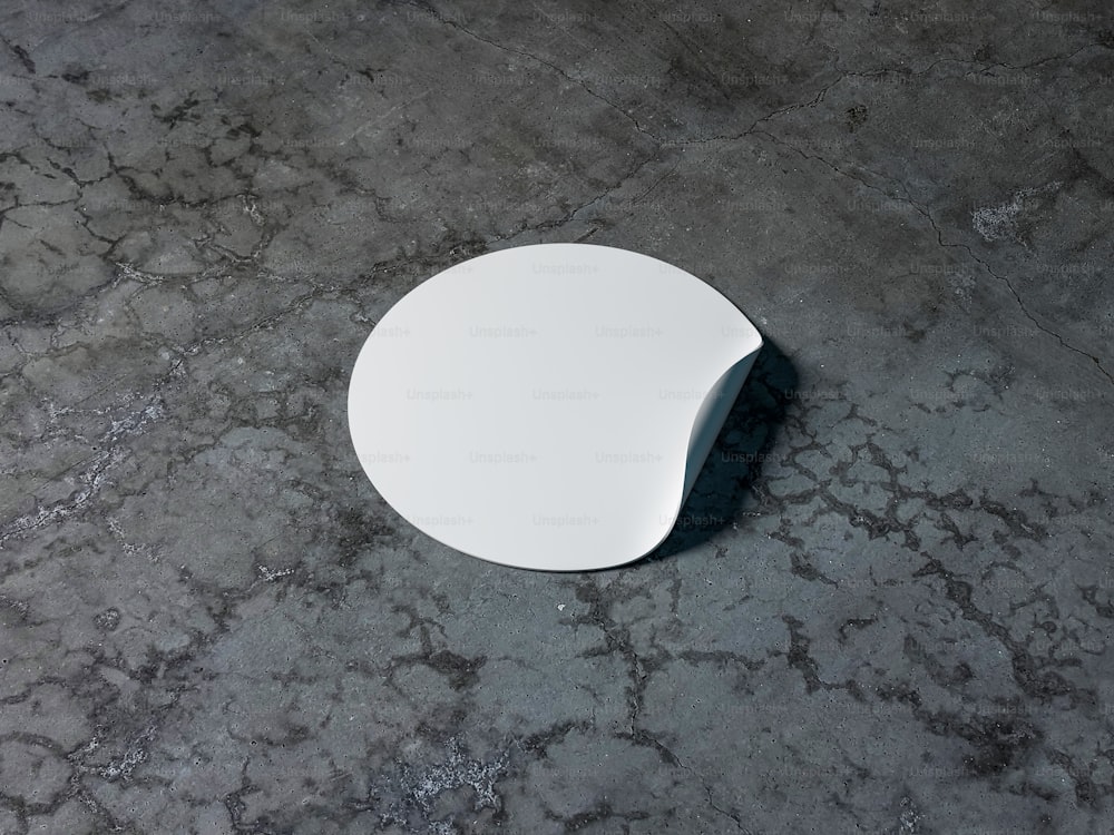 コンクリートテーブル上の空白の白い丸い粘着ステッカーモックアップ、3Dレンダリング