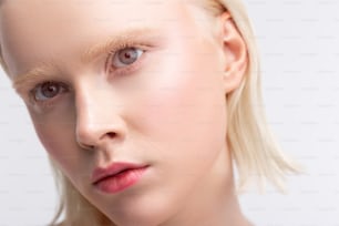 Light eyebrows. Beautiful young grey-eyed woman having light eyebrows and natural makeup