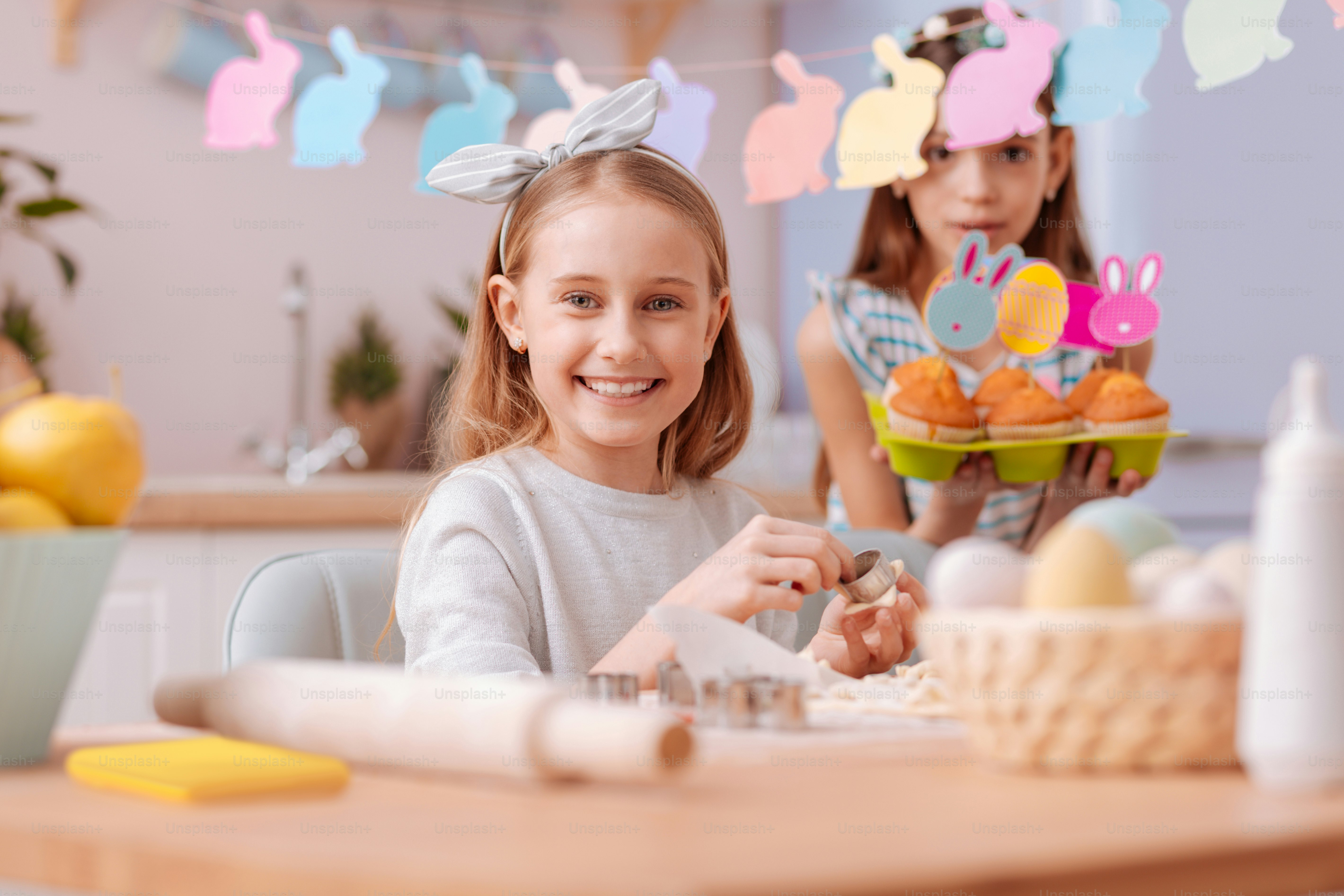 Happy family. Delighted little female preparing for Easter celebration and making cookies
