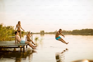 Young people having fun at the lake on a summer day