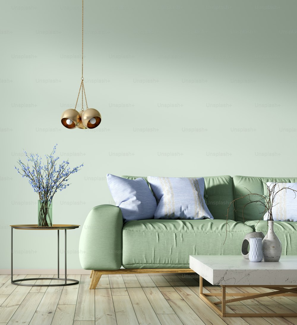 Modernes Interieur des Wohnzimmers mit grünem Sofa, Couchtischen und Lampe 3D-Rendering