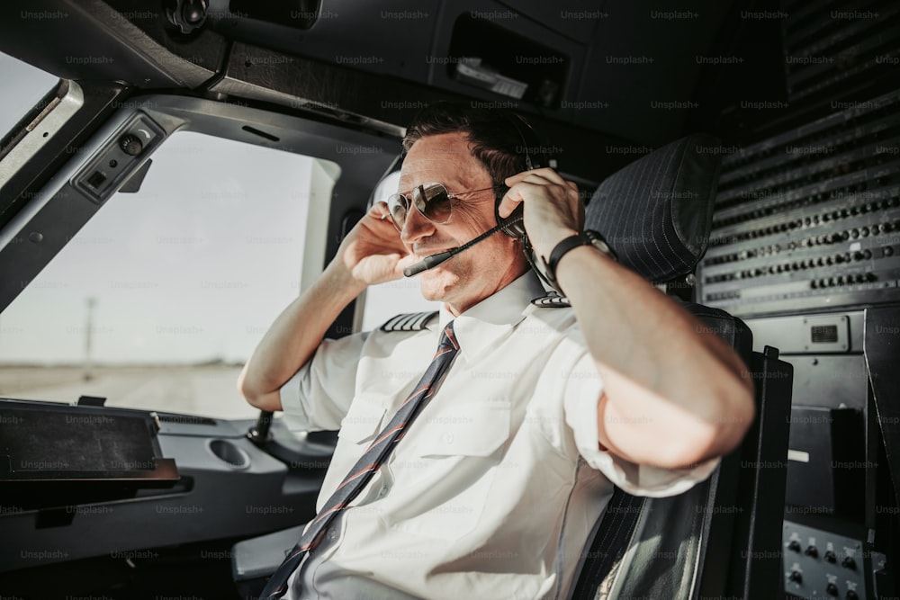 I like my job. Man in uniform preparing for taking off airport stock photo