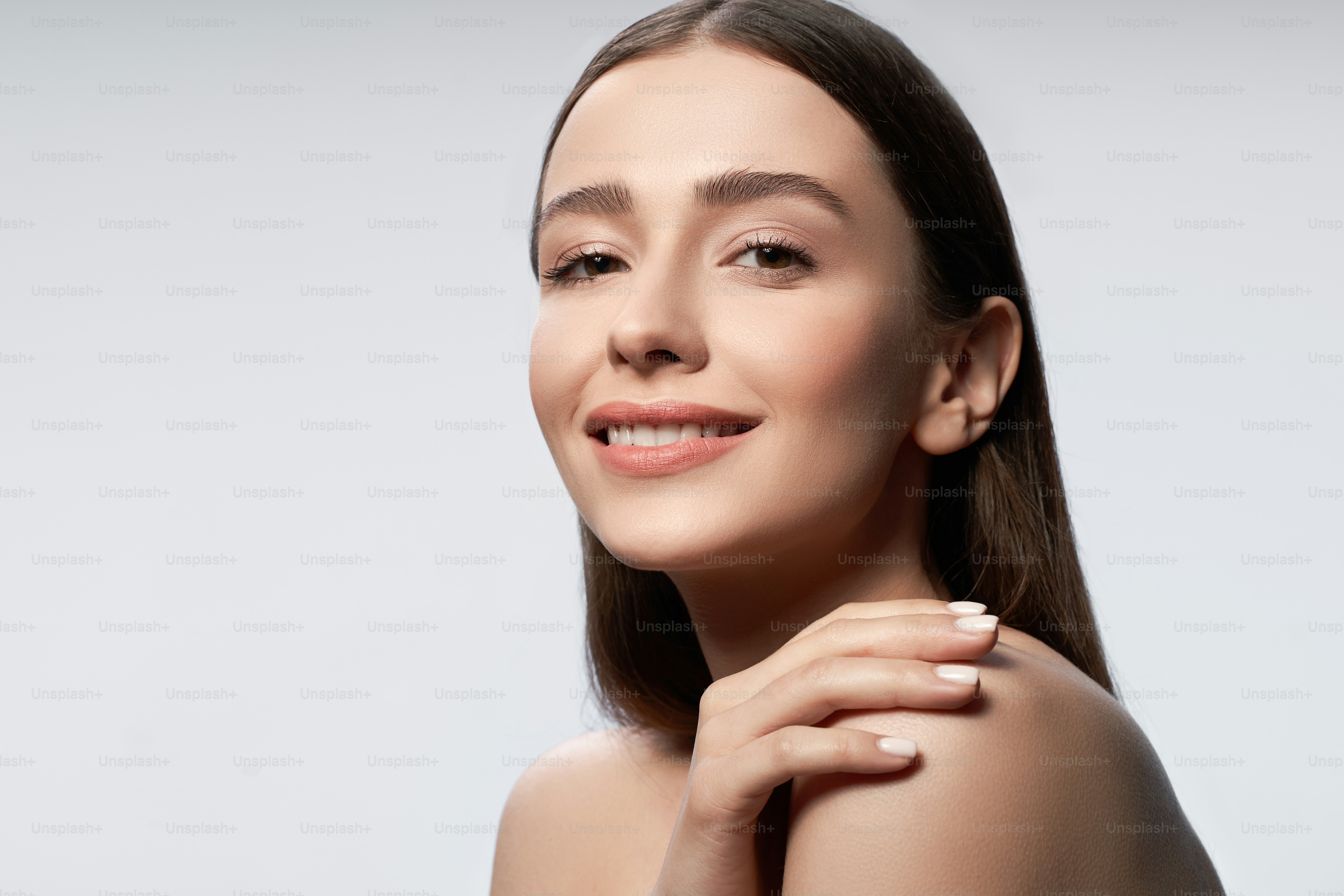 Close up portrait of beautiful lady with naked shoulders looking at ...