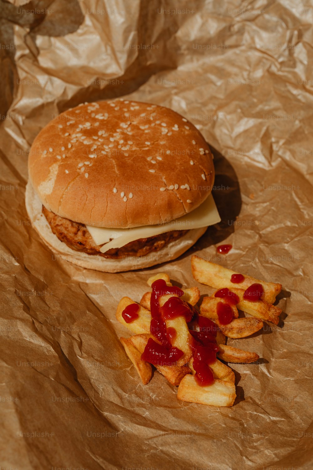 a chicken sandwich and fries on a piece of brown paper