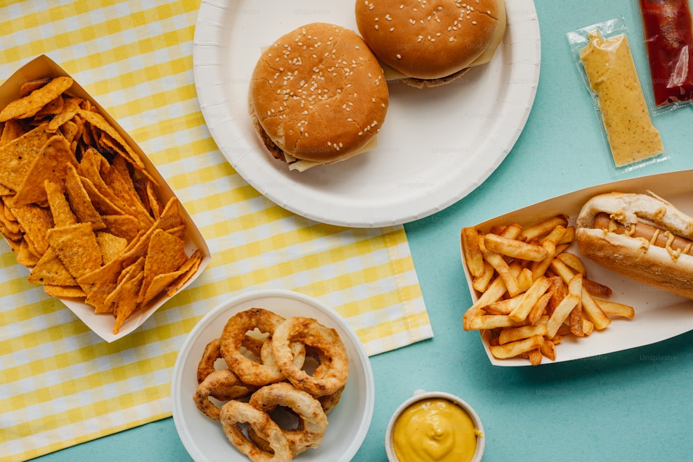 a table topped with plates of food and a hamburger