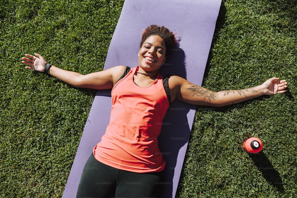 Smiling young woman resting on the grass stock photo