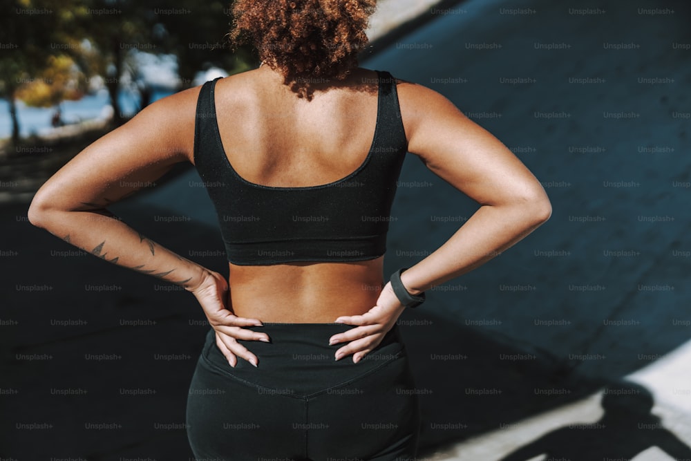 Athletic Afro American lady resting her hands on hips stock photo