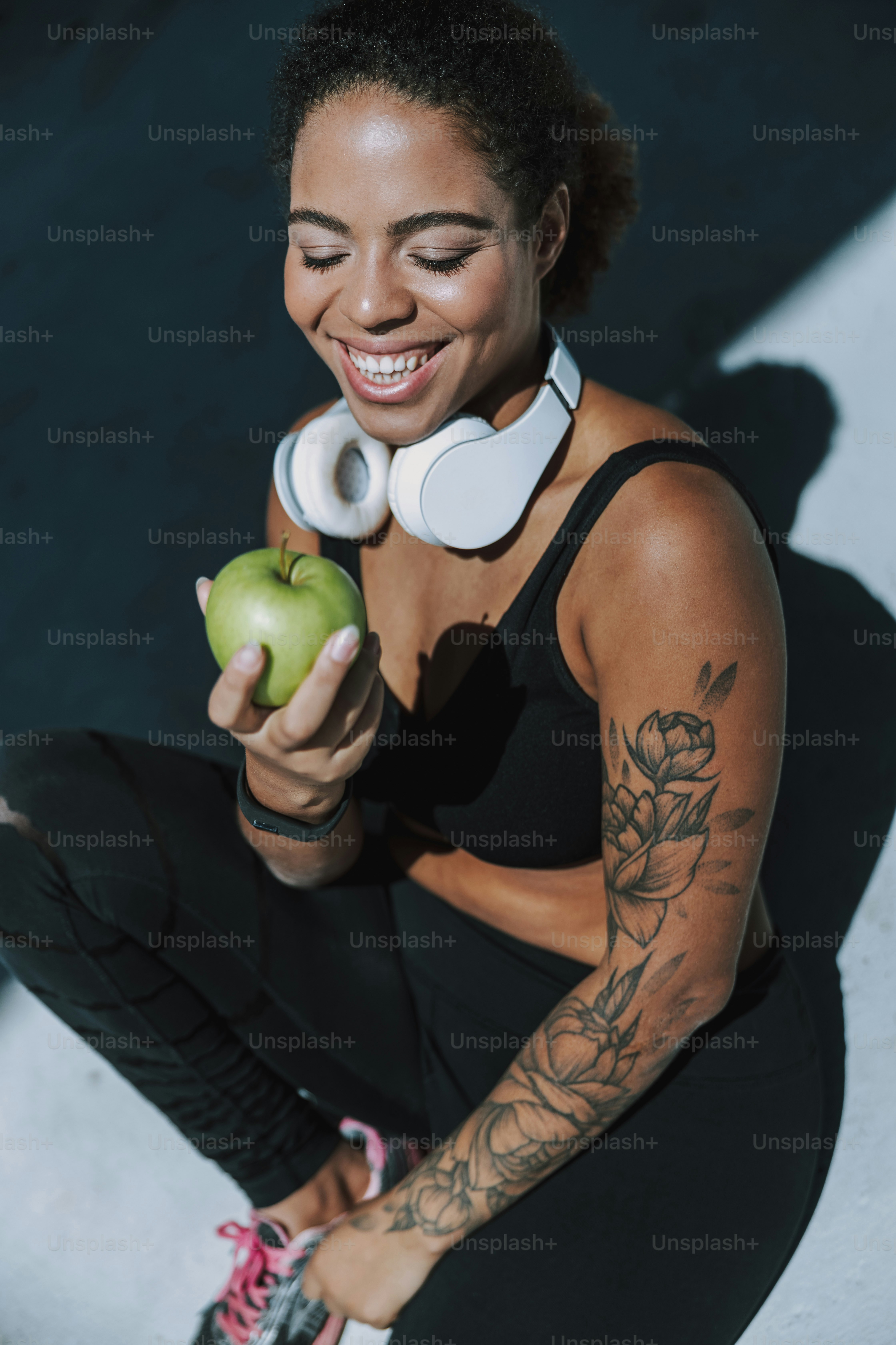 Beautiful young woman with fresh fruit spending time outdoors stock photo