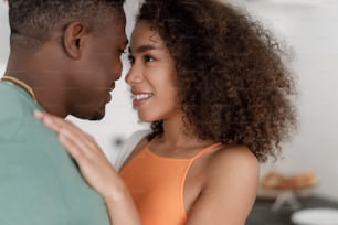 Charming lady gazing at her boyfriend and smiling stock photo