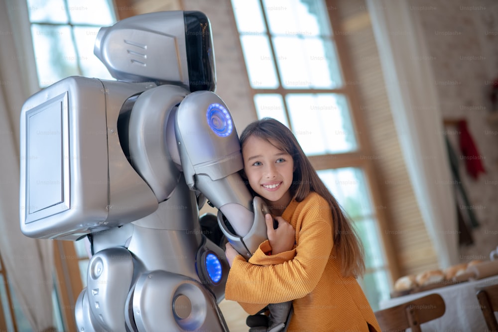 Human dn robot. Cute girl feeling good with her robot friend hugging him