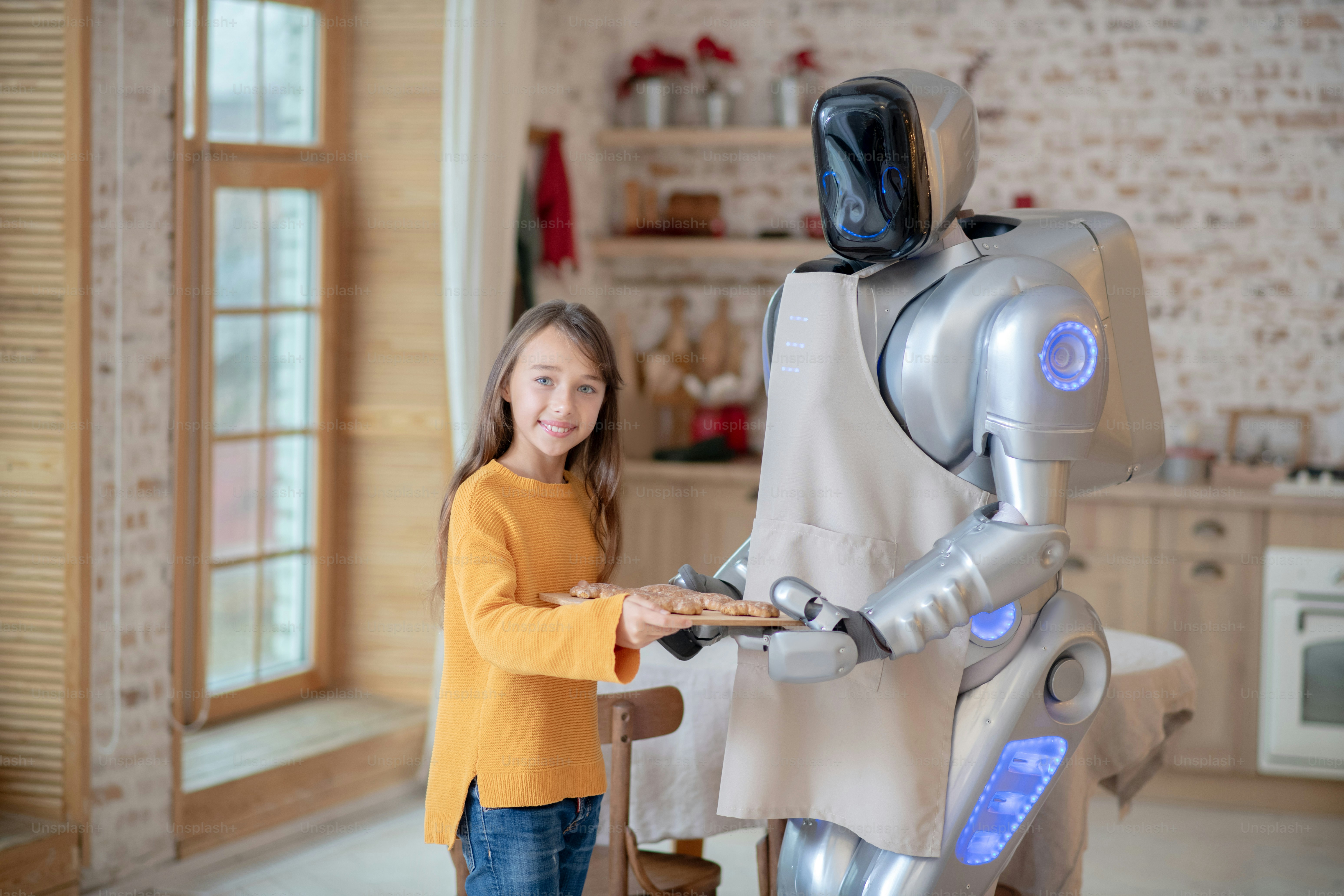 In der Schürze. Hausroboter in Schürze steht in der Kicthen bereit zum  Kochen des Abendessens Foto – Bild zum Thema Essen auf Unsplash, image size:3000x2000