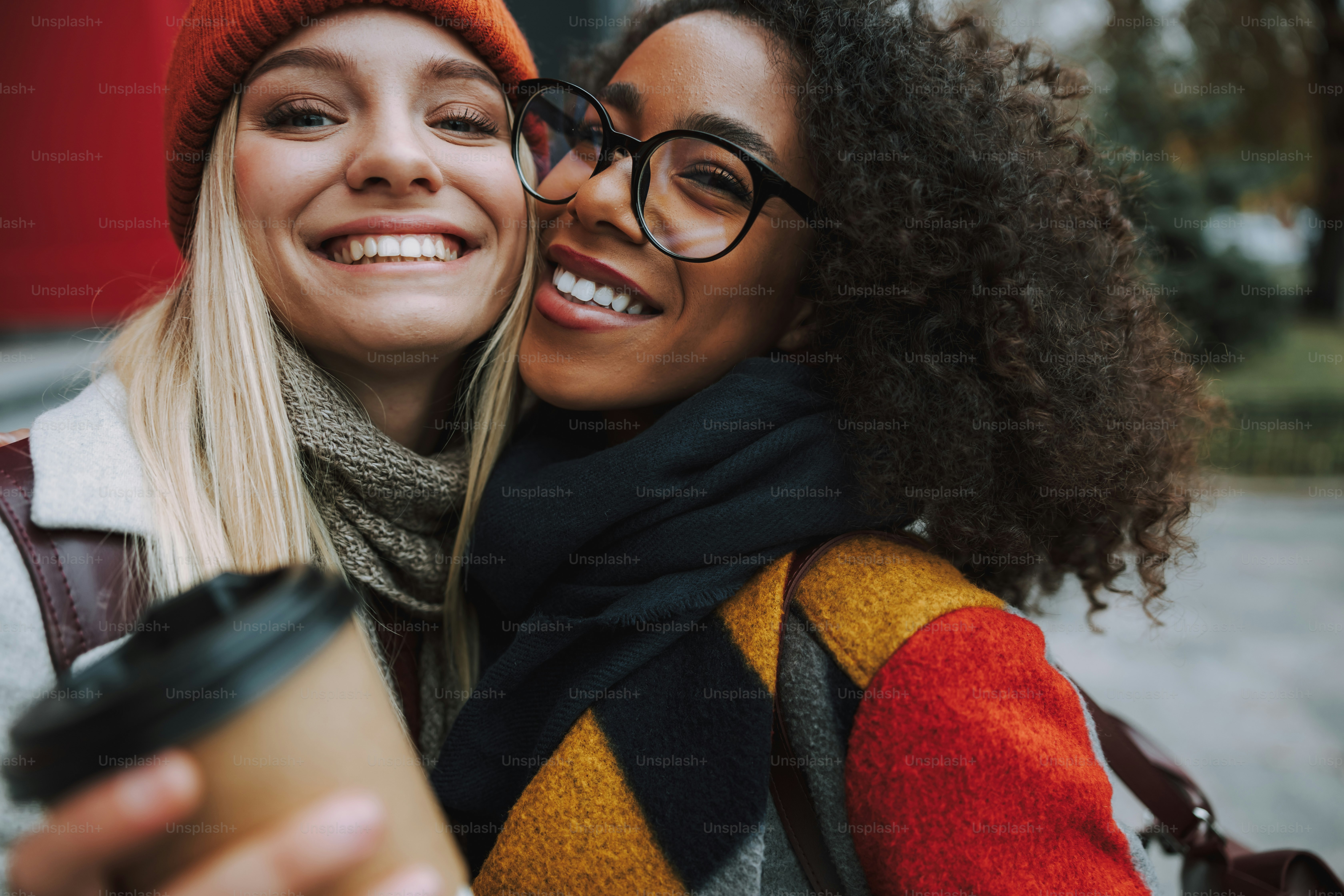 Cheerful and happy female students walking together stock photo
