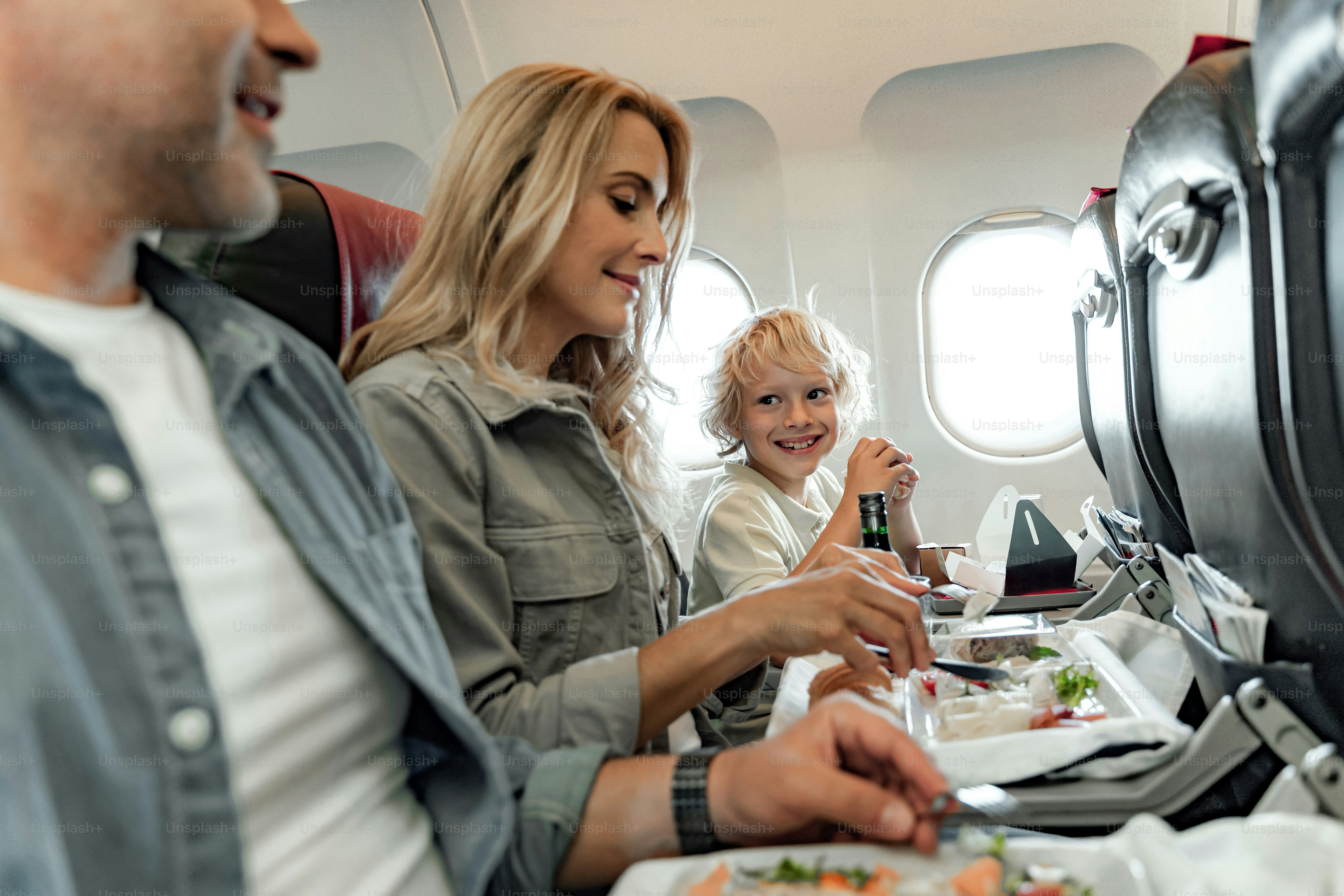 Smiling little boy looking on his parents in cabin stock photo