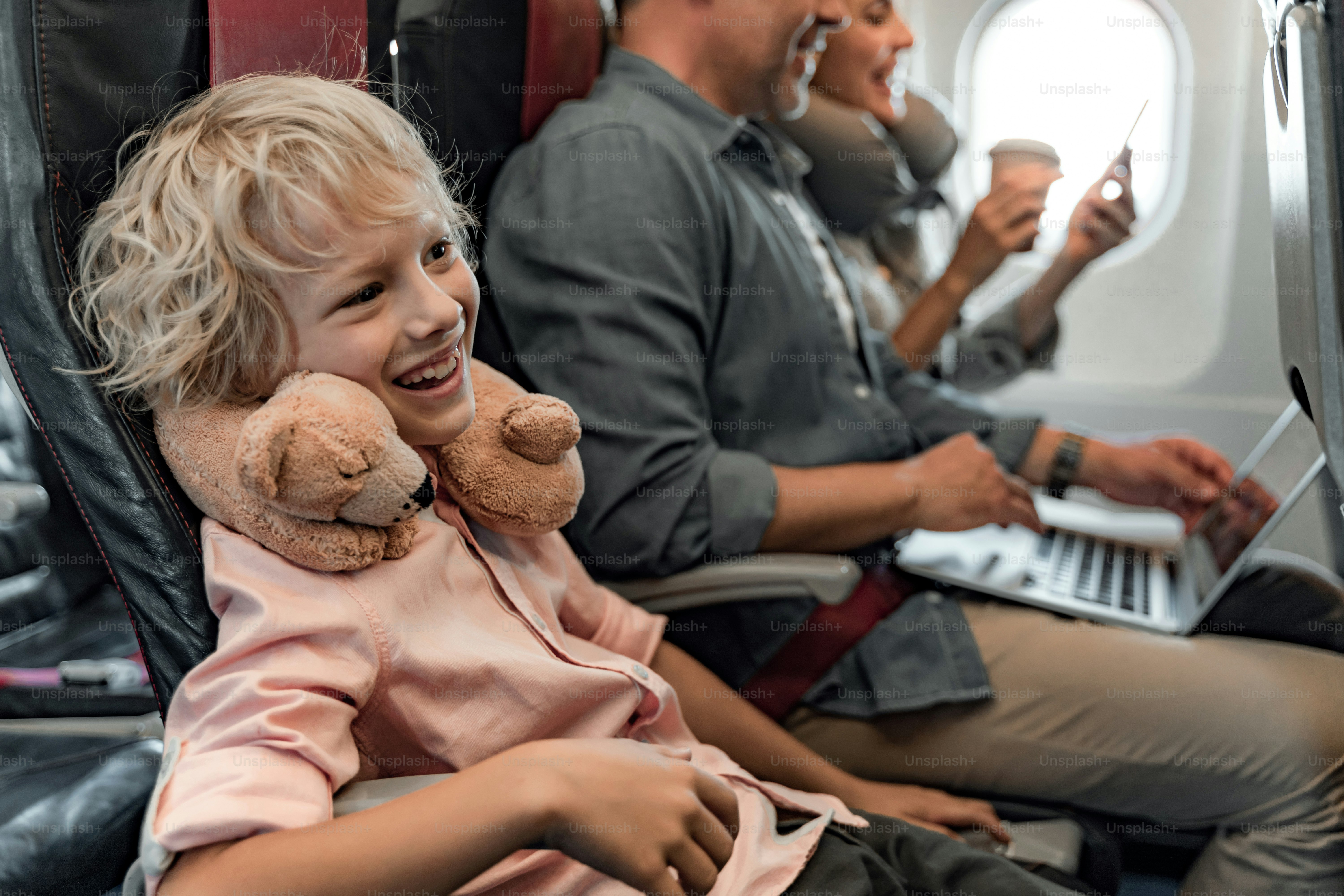 Happy son having fun near his parents in cabin stock photo