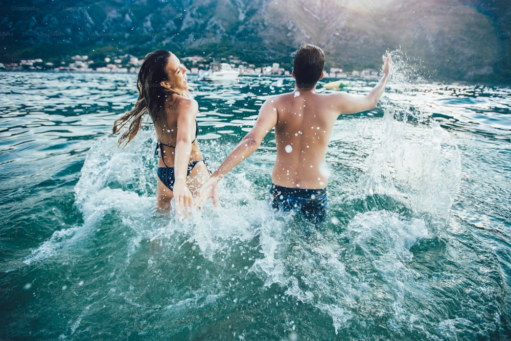 Attractive young couple on the beach having fun