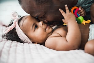 Close up of smiling dad pressing nose to face of adorable child stock photo