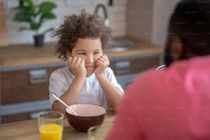 Moody kid. Cute little kid looking moody having no appetite