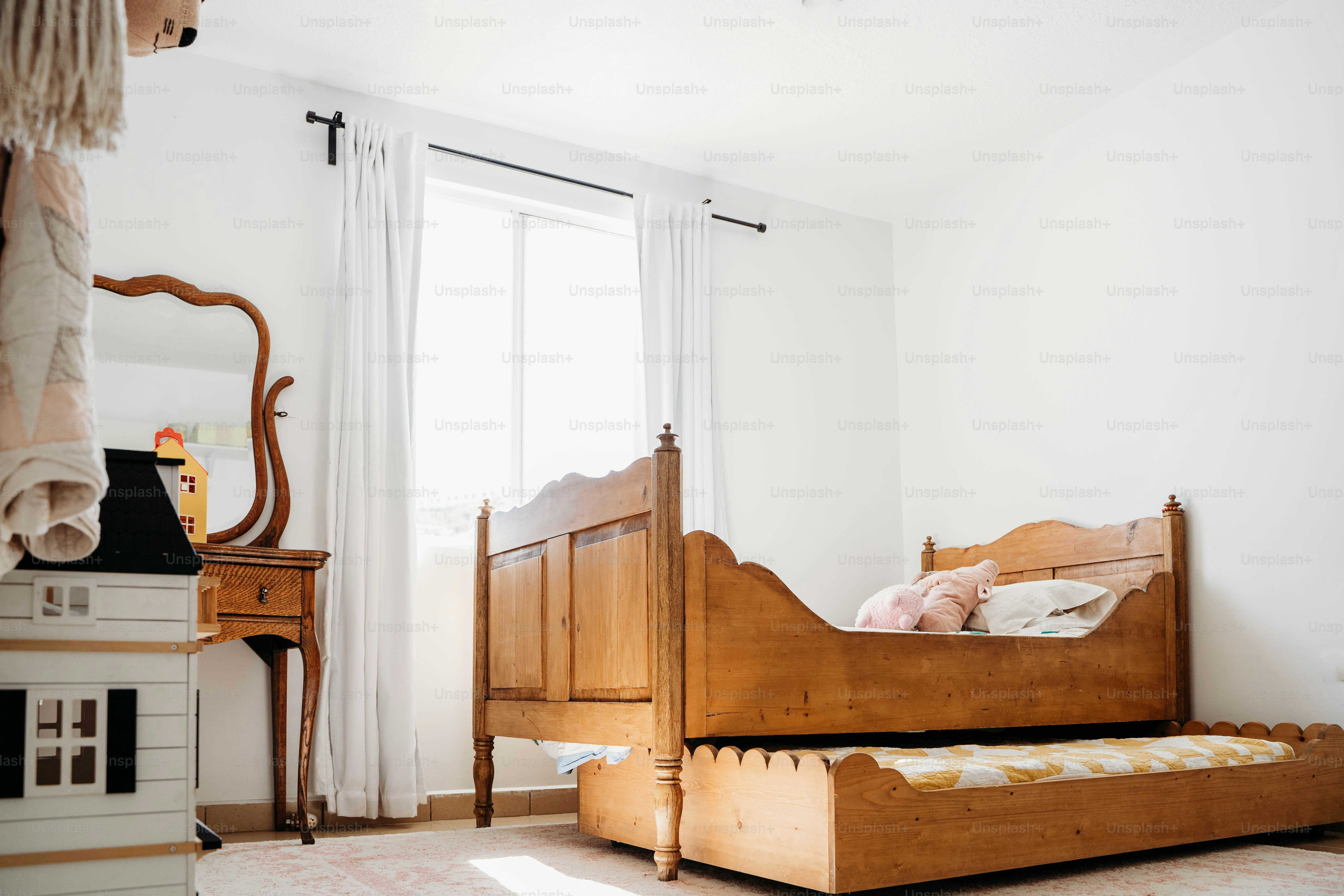 a bedroom with a bed, dresser and mirror