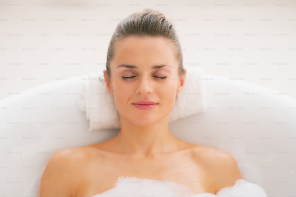 Young woman relaxing in bathtub