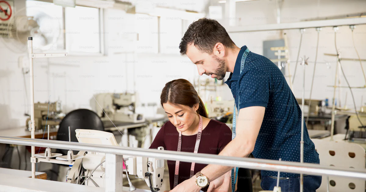 Male supervisor and a female tailor looking for ways to improve work in ...