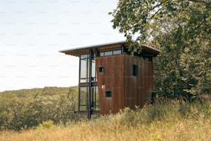 a small wooden structure in the middle of a field